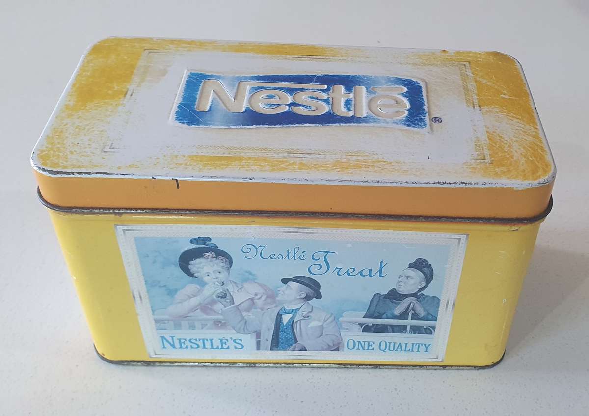 NESTLE tin as per photo