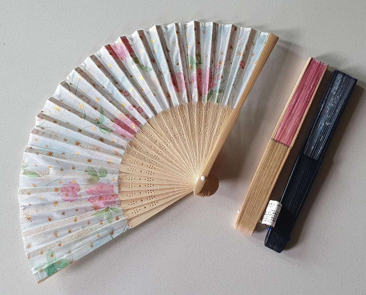 One light blue colour hand-held folding fan as per photo