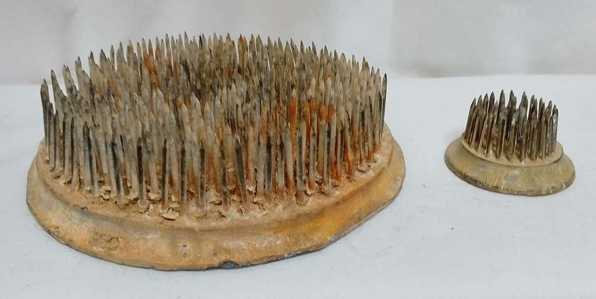 Two vintage metal flower frogs