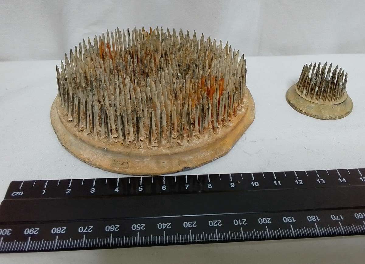 Two vintage metal flower frogs