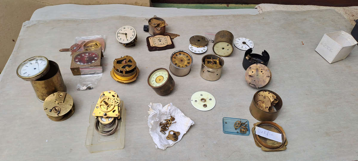 collection of small vintage clock movements for spares or repairs