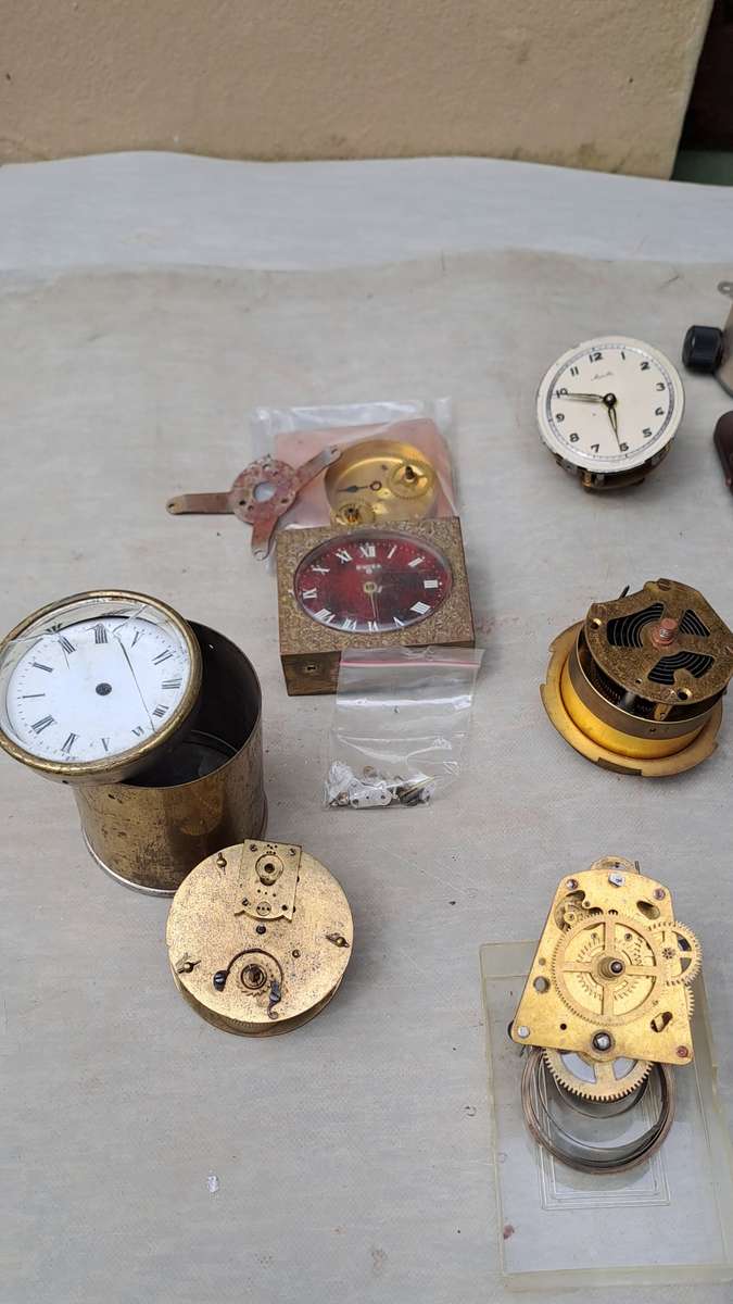 collection of small vintage clock movements for spares or repairs