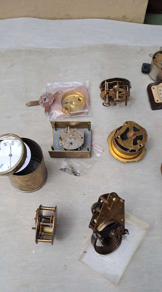 collection of small vintage clock movements for spares or repairs