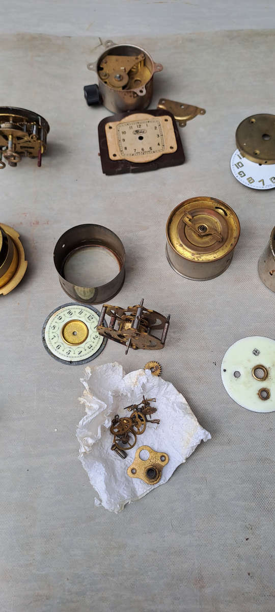 collection of small vintage clock movements for spares or repairs