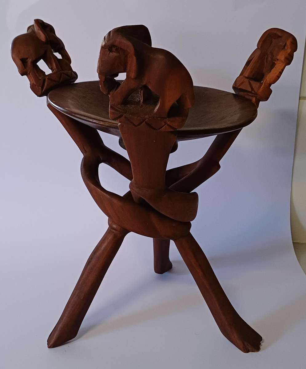 African dish on hand-carved wooden tripod with elephants