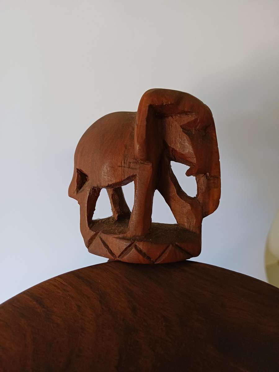 African dish on hand-carved wooden tripod with elephants