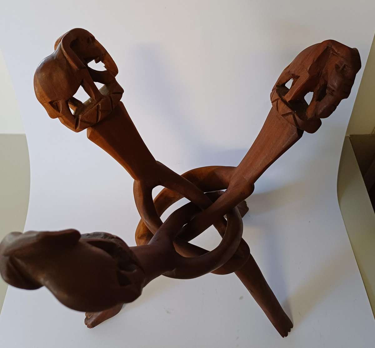 African dish on hand-carved wooden tripod with elephants