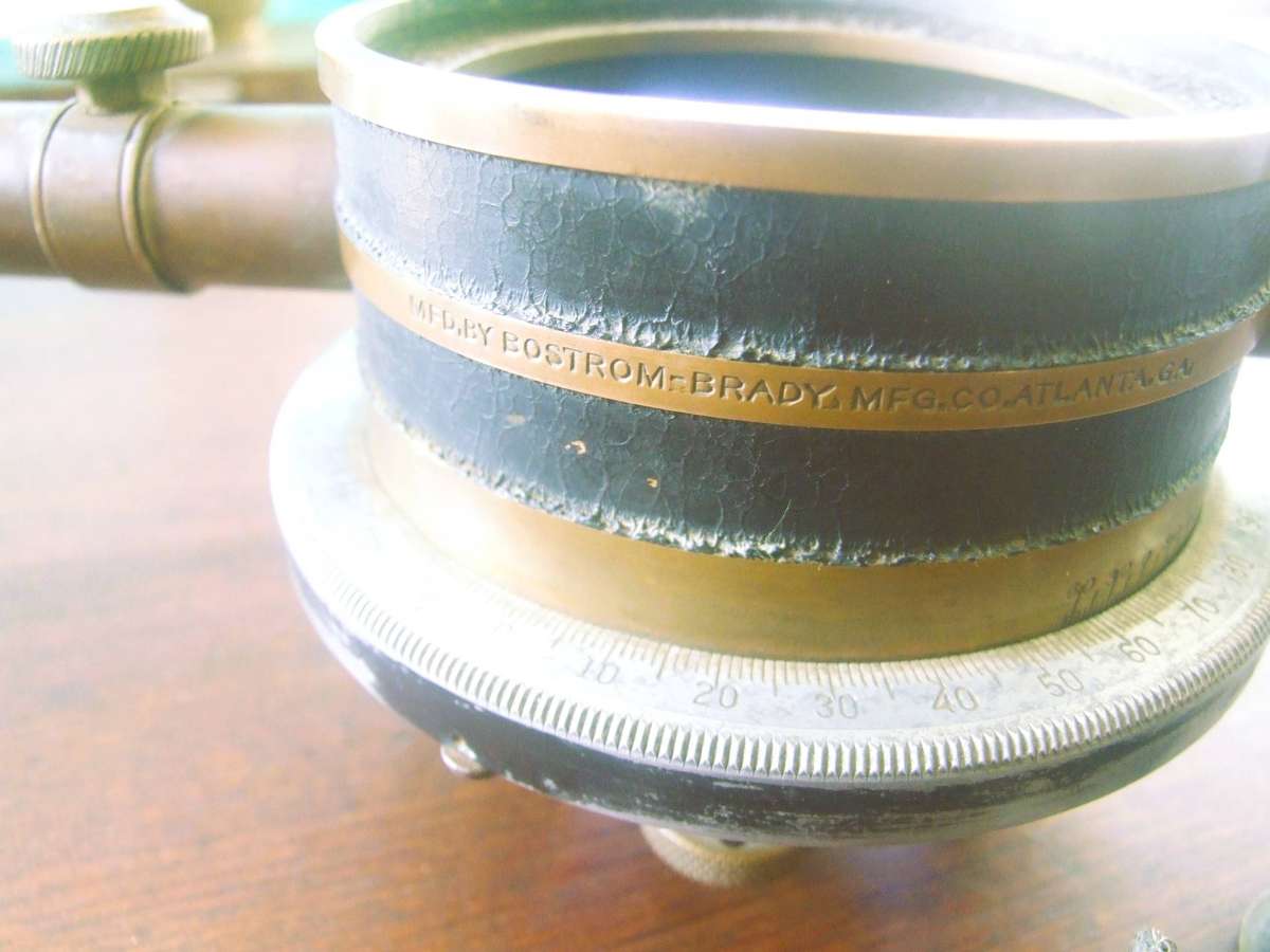 a vintage surveying instrument, specifically identified as a Bostrom Model 4 Contractors Transit Lev