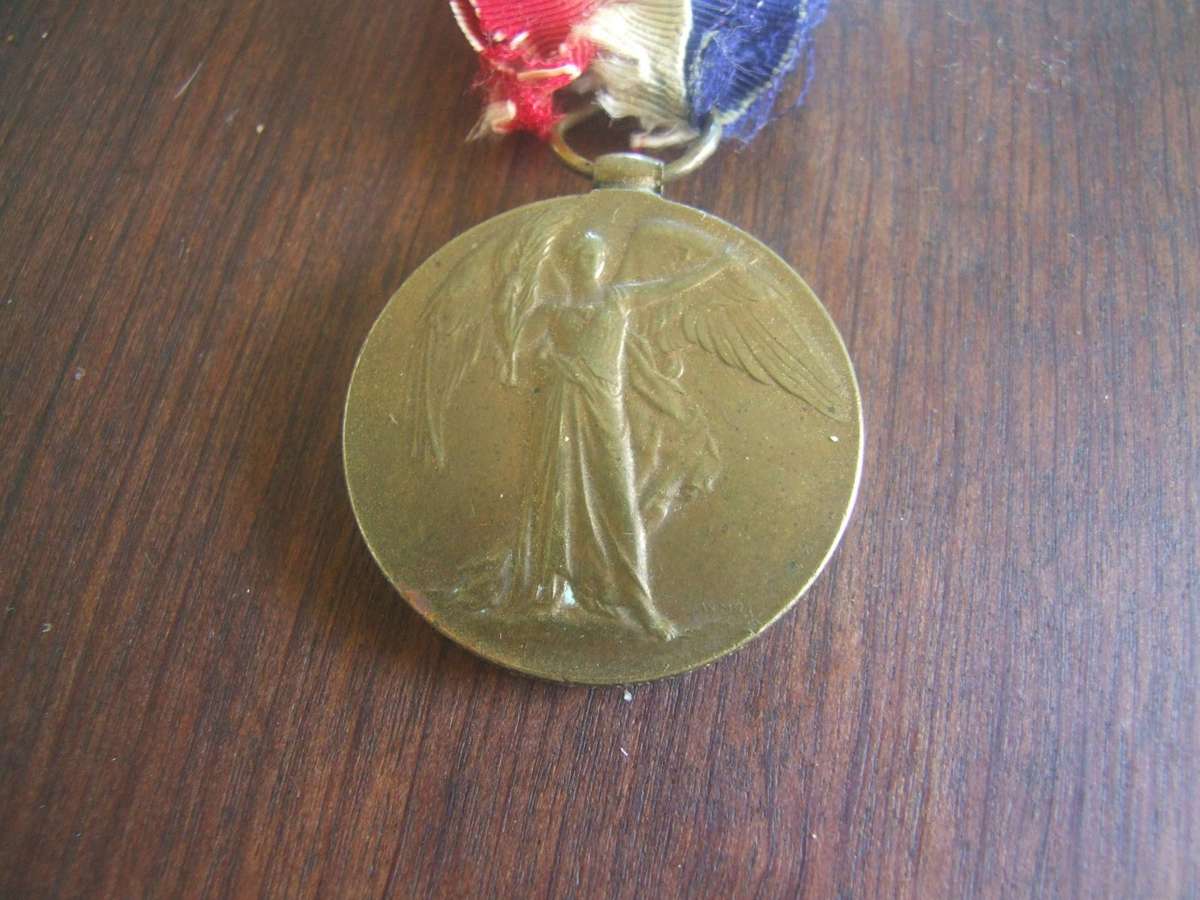 @    an original  World War I Victory Medal,  the South African version, which features a wing