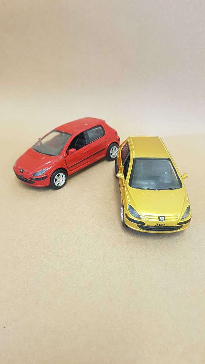Two Peugeot 307 scale model cars. Dated 2002.