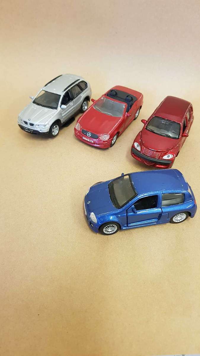 4 Scale model Maisto cars. Renault Clio , Chrysler PT Cruiser ,Mercedes SLK and BMW X5.