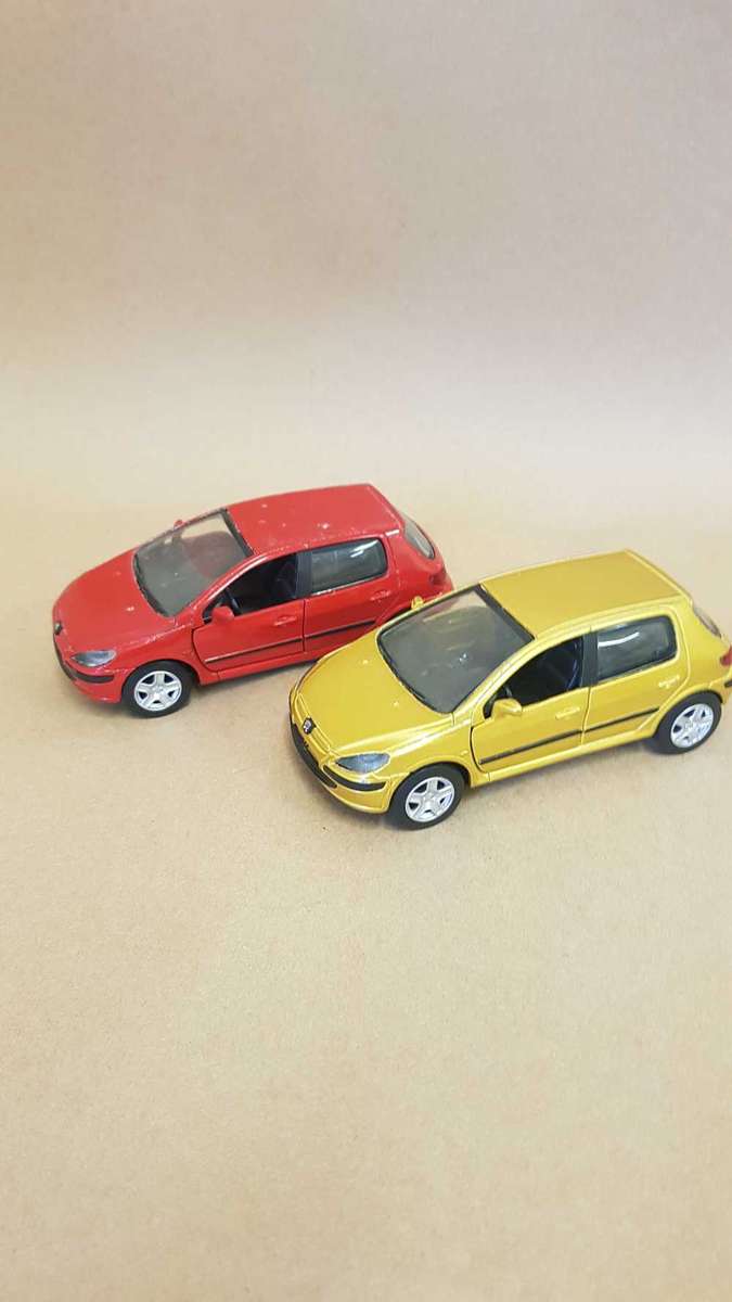 Two Peugeot 307 scale model cars. Dated 2002.