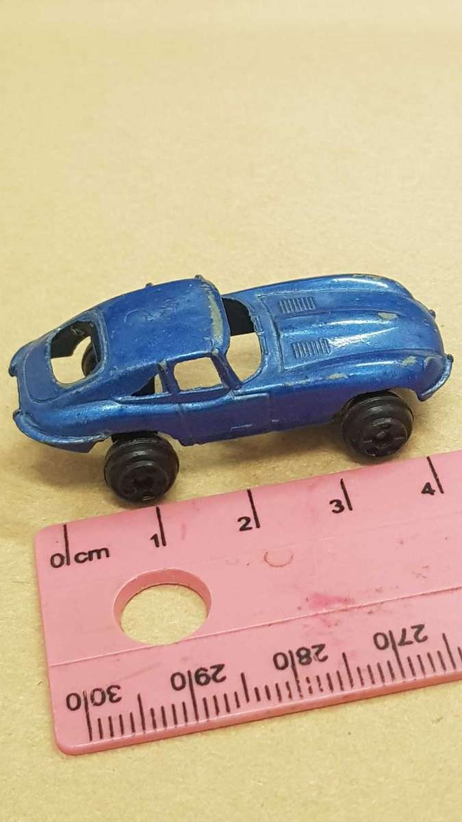 Two metal die cast toy cars. VW Bettle and e-type Jaguar.