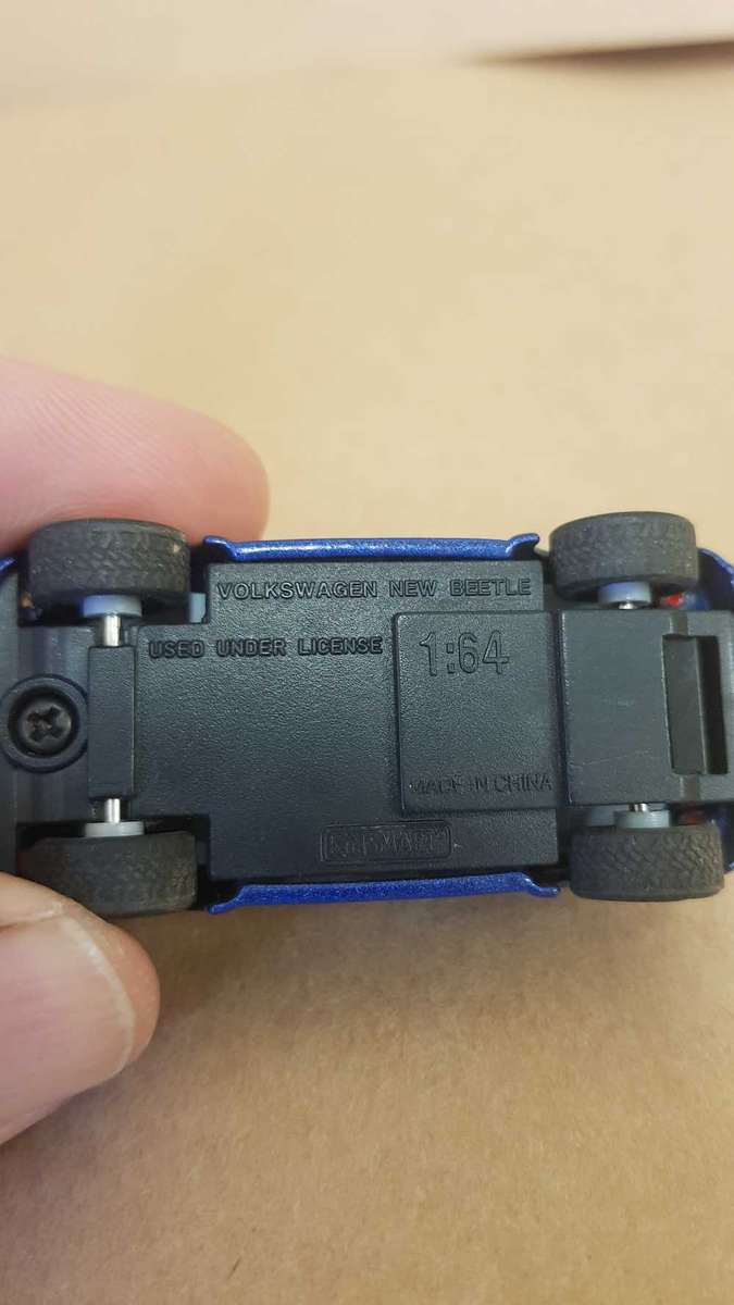 1:64 scale VW Beetle . By Kinsmart. With surfboard on roof.