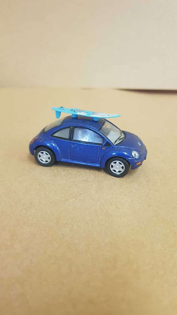1:64 scale VW Beetle . By Kinsmart. With surfboard on roof.