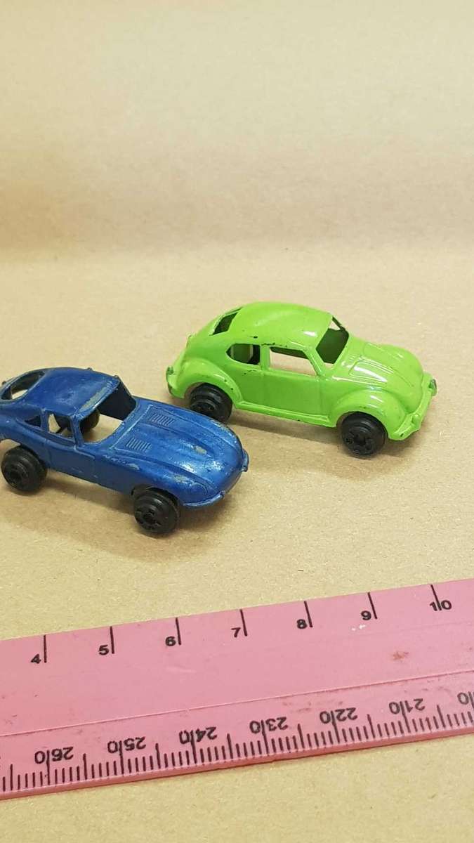 Two metal die cast toy cars. VW Bettle and e-type Jaguar.