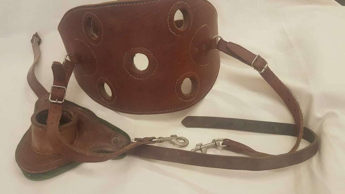 Heavy leather fishing harness with leather fishing rod bucket.