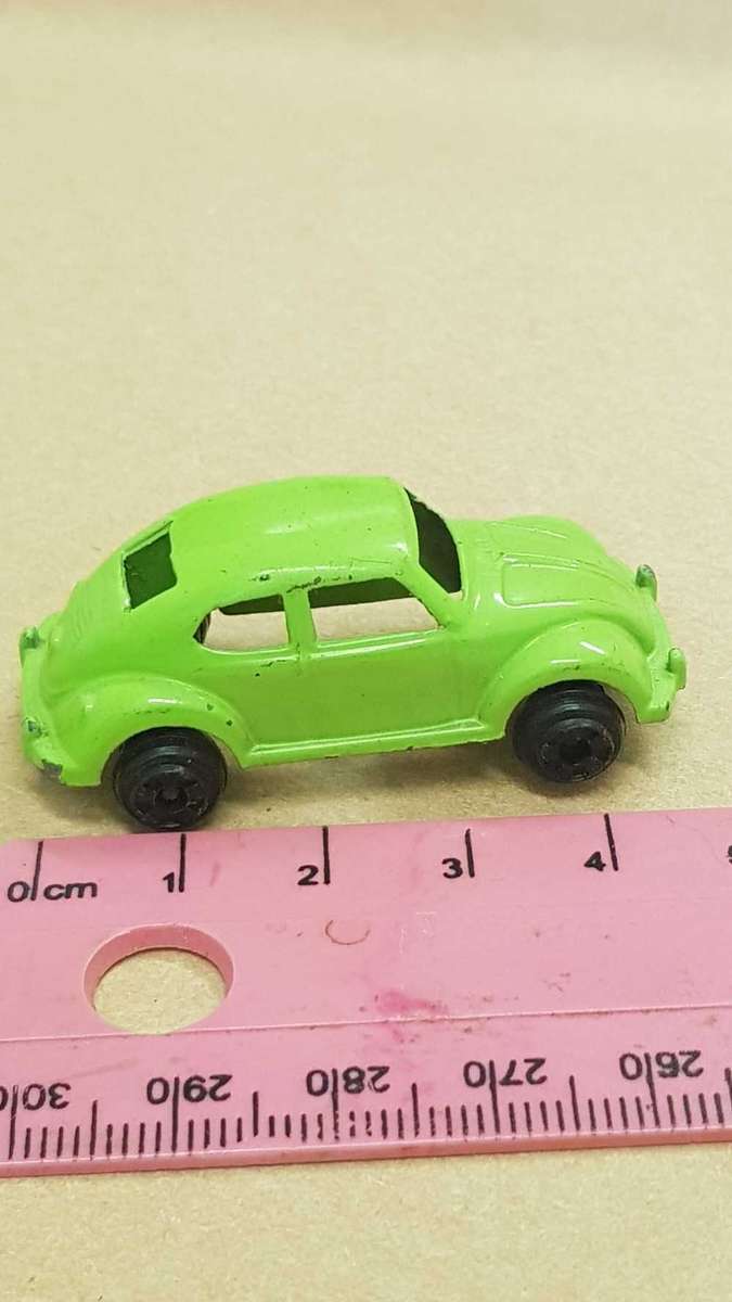 Two metal die cast toy cars. VW Bettle and e-type Jaguar.