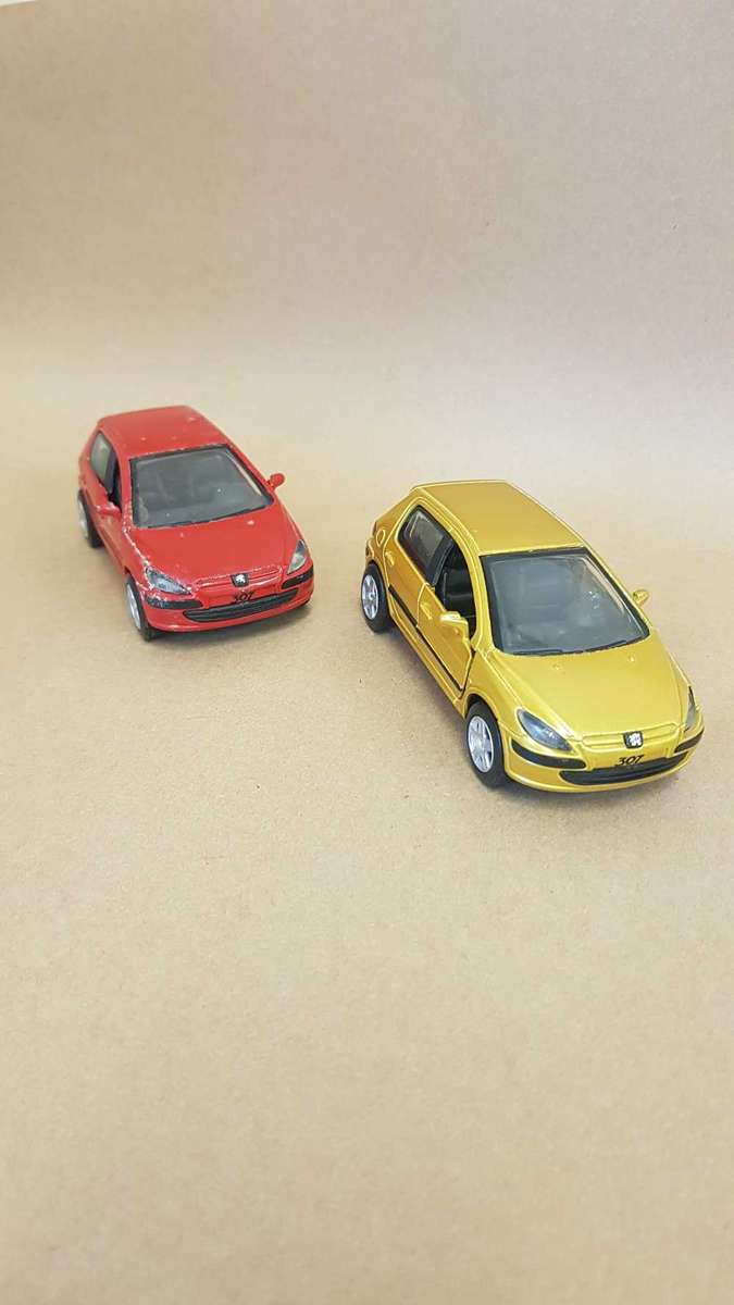 Two Peugeot 307 scale model cars. Dated 2002.
