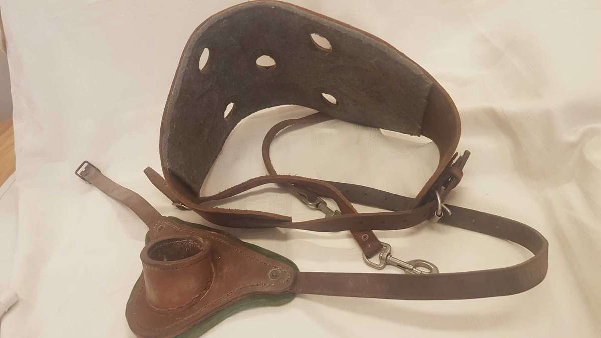 Heavy leather fishing harness with leather fishing rod bucket.