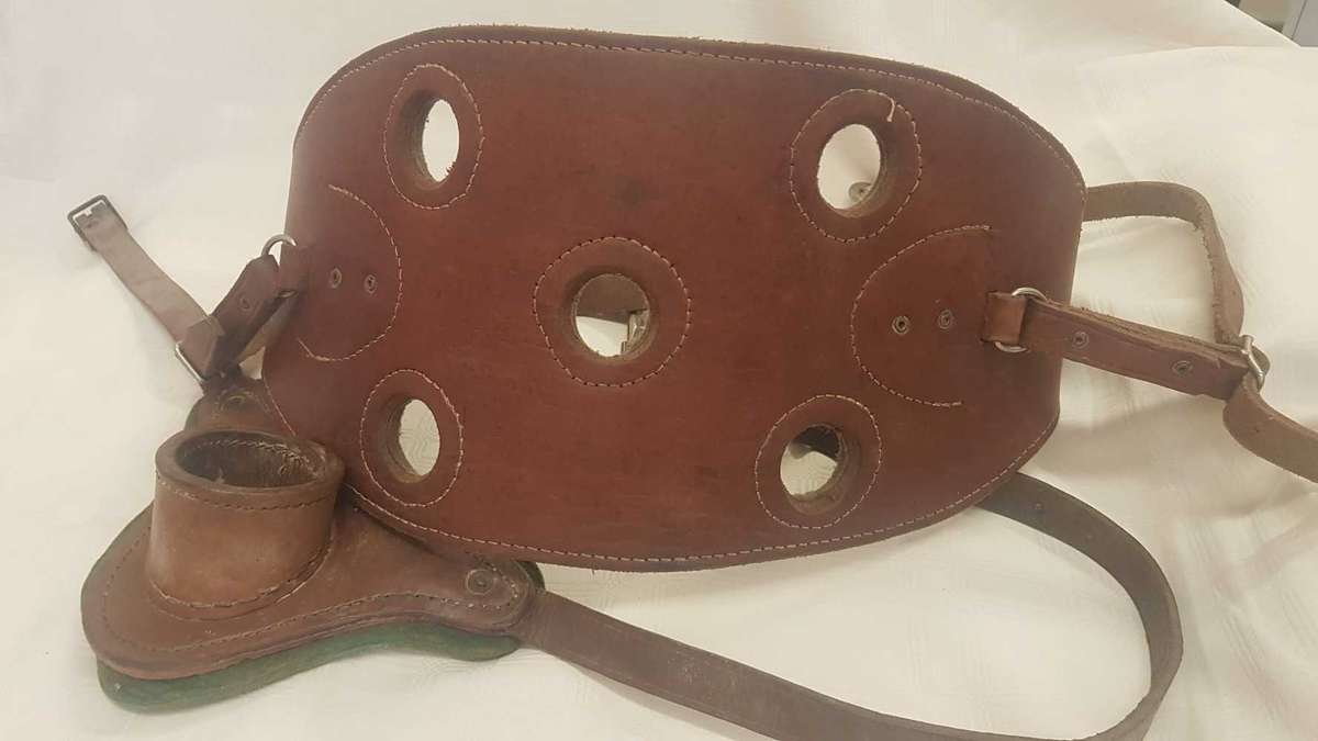 Heavy leather fishing harness with leather fishing rod bucket.