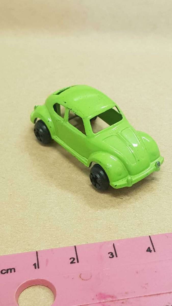 Two metal die cast toy cars. VW Bettle and e-type Jaguar.