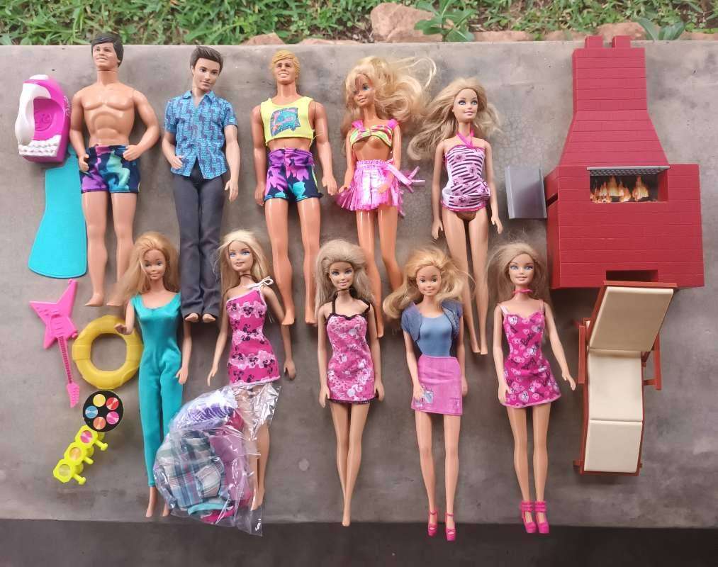 Various Barbie and Ken dolls and accessories