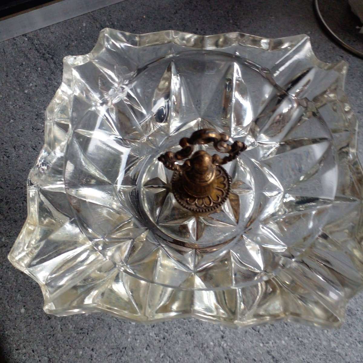 Vintage heavy crystal glass ashtray with an ornate brass stand.