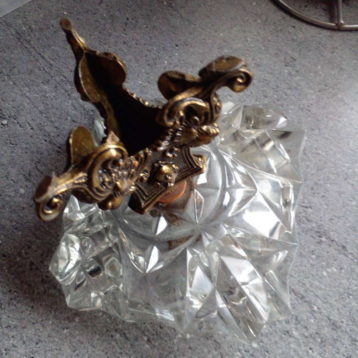 Vintage heavy crystal glass ashtray with an ornate brass stand.