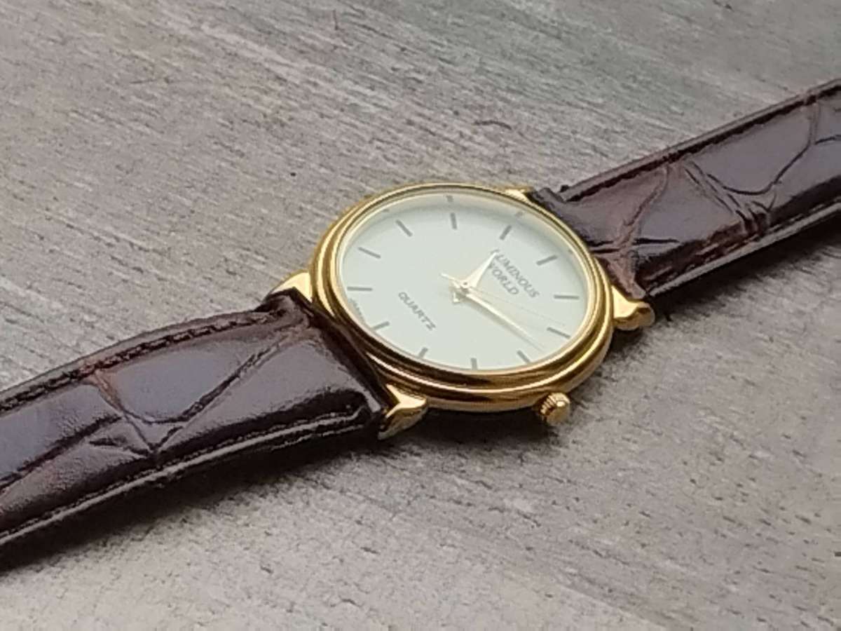 LADIES LUMINOUS WORLD GOLD WATCH WITH STUNNING BROWN LEATHER STRAP IN EXCELLENT WORKING CONDITION