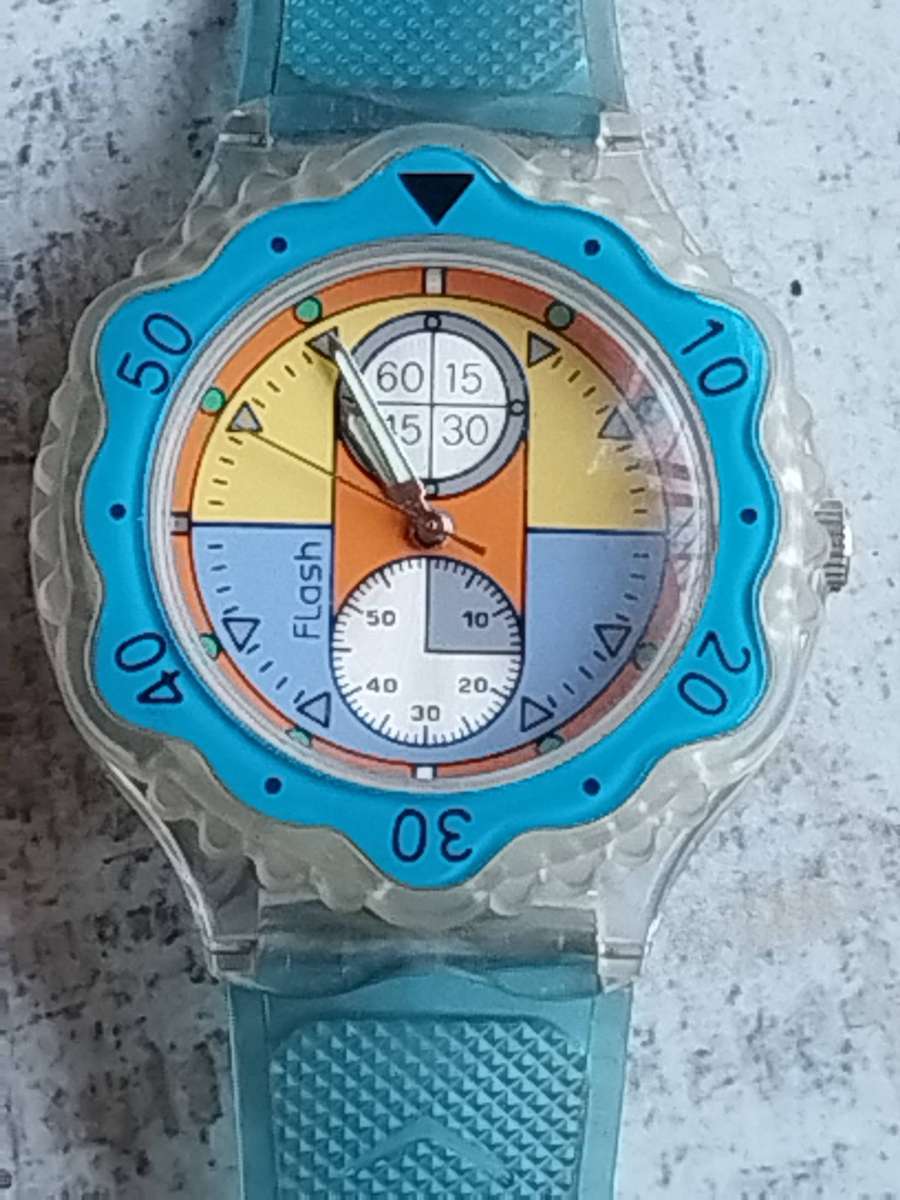 MENS FLASH SPORTS WATCH WITH ROTATING BEZEL AND SEE-THROUGH BACK IN EXCELLENT WORKING CONDITION