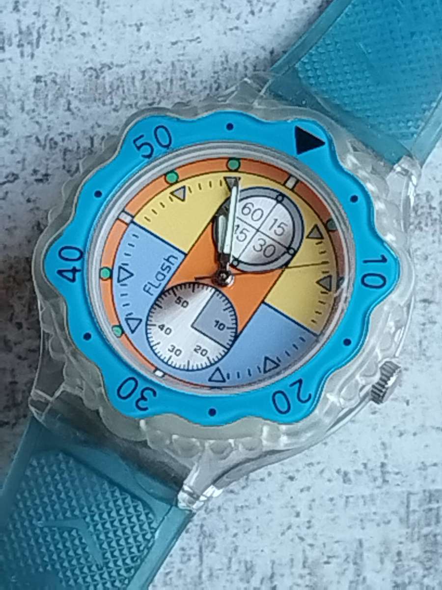 MENS FLASH SPORTS WATCH WITH ROTATING BEZEL AND SEE-THROUGH BACK IN EXCELLENT WORKING CONDITION