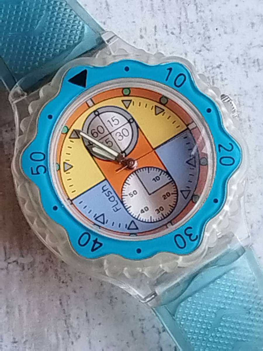 MENS FLASH SPORTS WATCH WITH ROTATING BEZEL AND SEE-THROUGH BACK IN EXCELLENT WORKING CONDITION