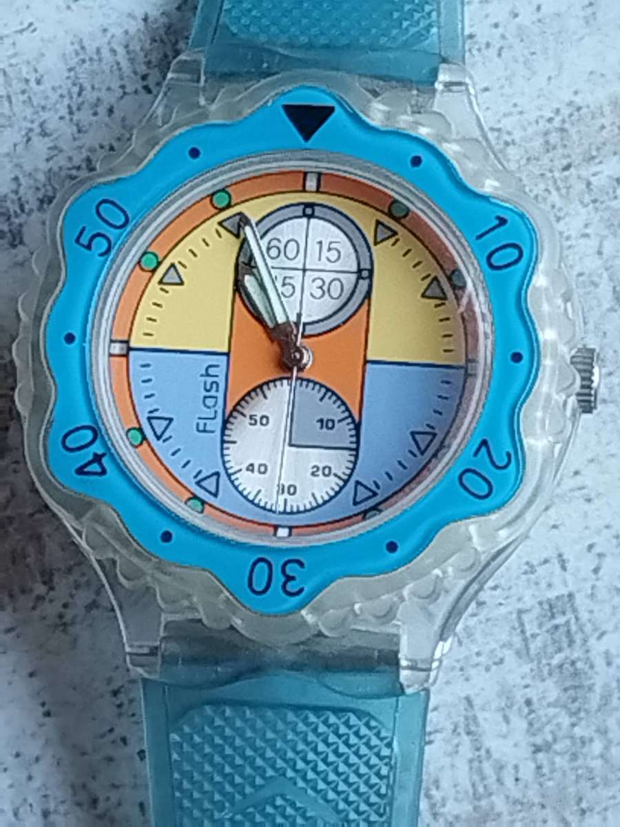 MENS FLASH SPORTS WATCH WITH ROTATING BEZEL AND SEE-THROUGH BACK IN EXCELLENT WORKING CONDITION