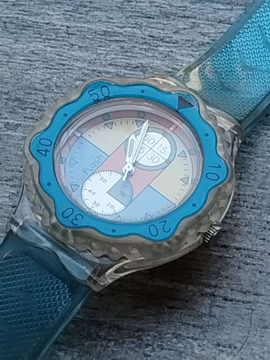 MENS FLASH SPORTS WATCH WITH ROTATING BEZEL AND SEE-THROUGH BACK IN EXCELLENT WORKING CONDITION