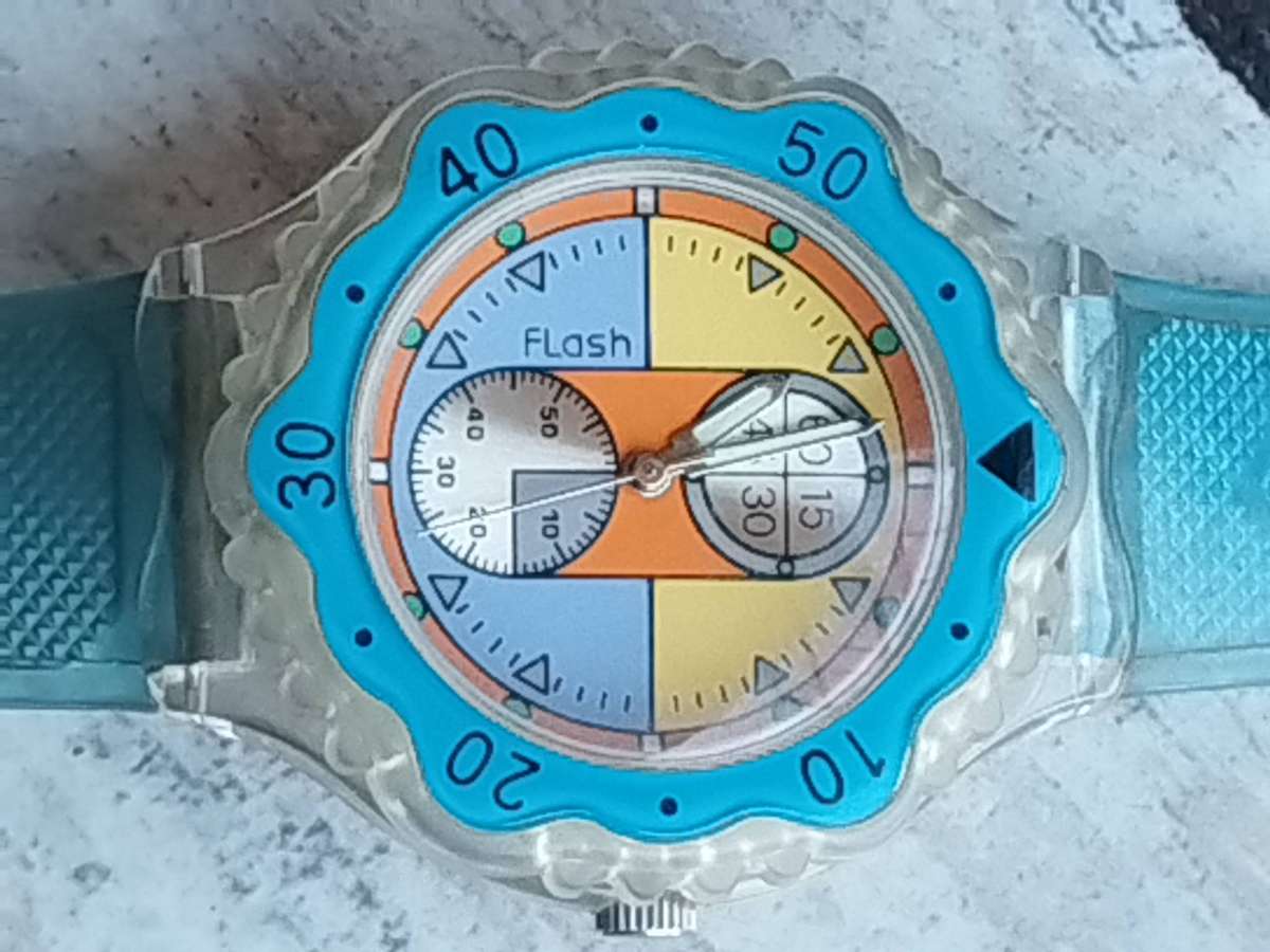 MENS FLASH SPORTS WATCH WITH ROTATING BEZEL AND SEE-THROUGH BACK IN EXCELLENT WORKING CONDITION