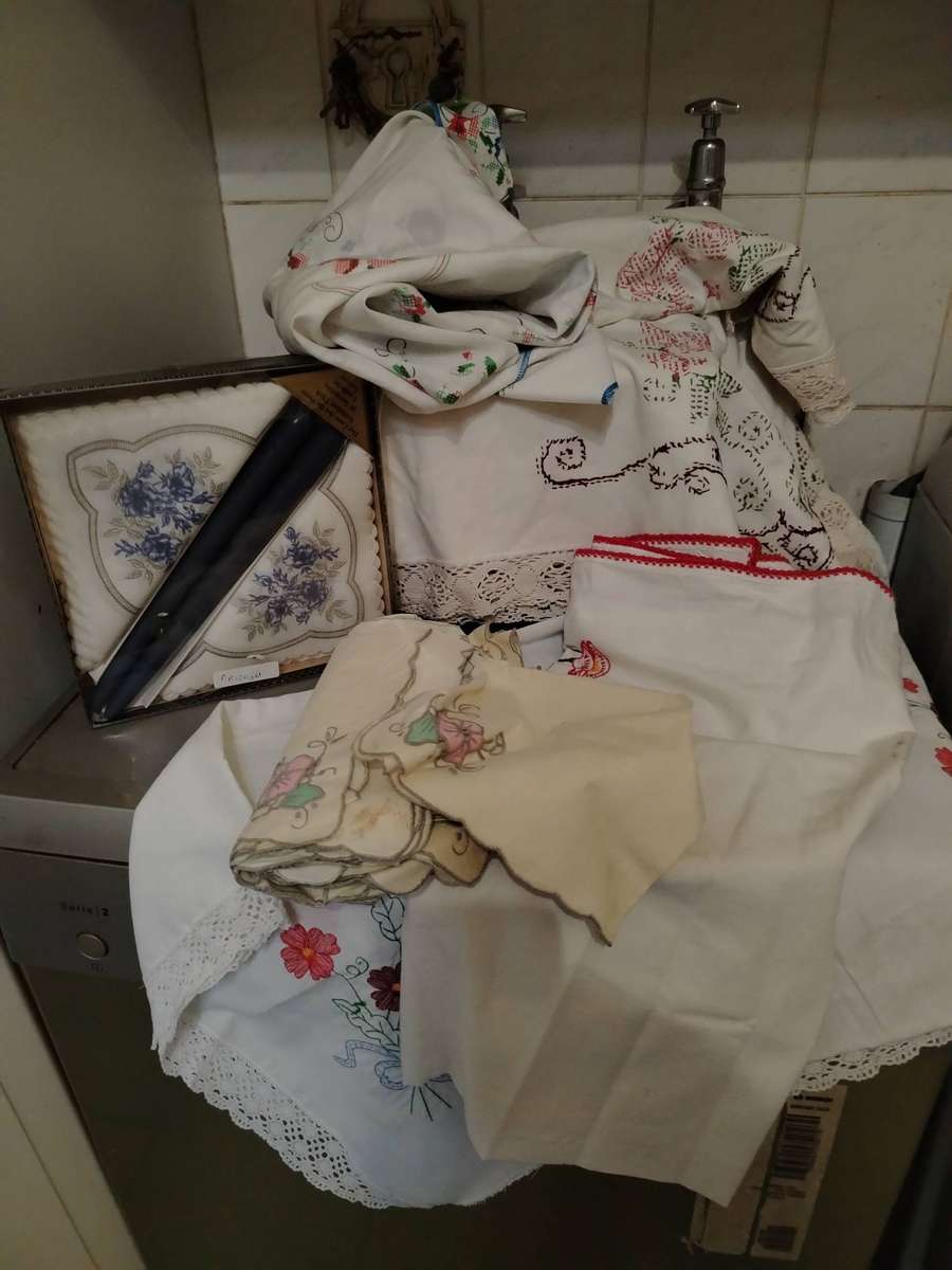 A Wooden storage box with table linen and etc