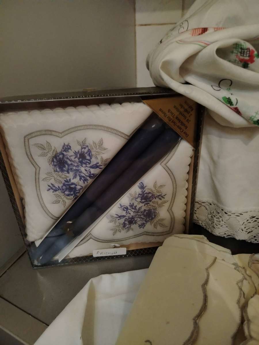 A Wooden storage box with table linen and etc