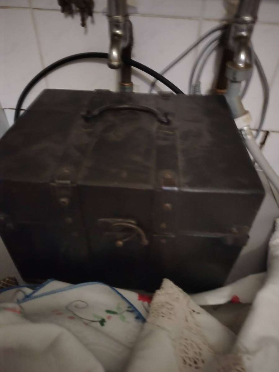 A Wooden storage box with table linen and etc