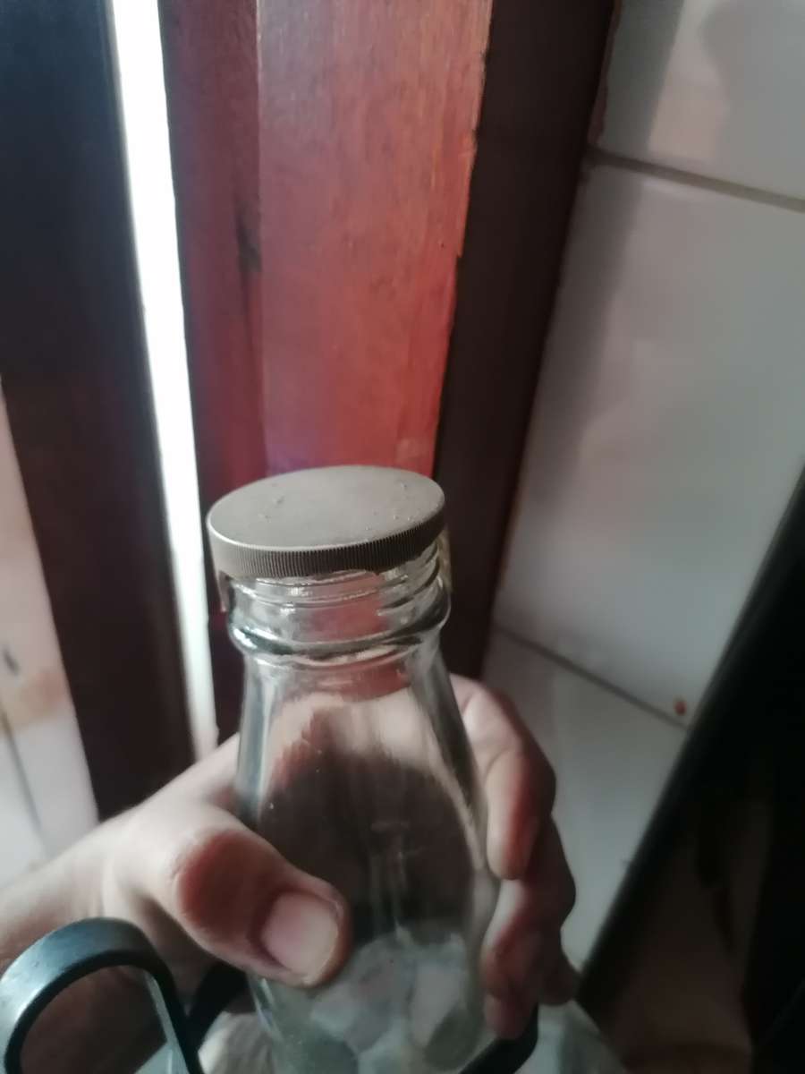 Large White Horse whiskey bottle on a stand.