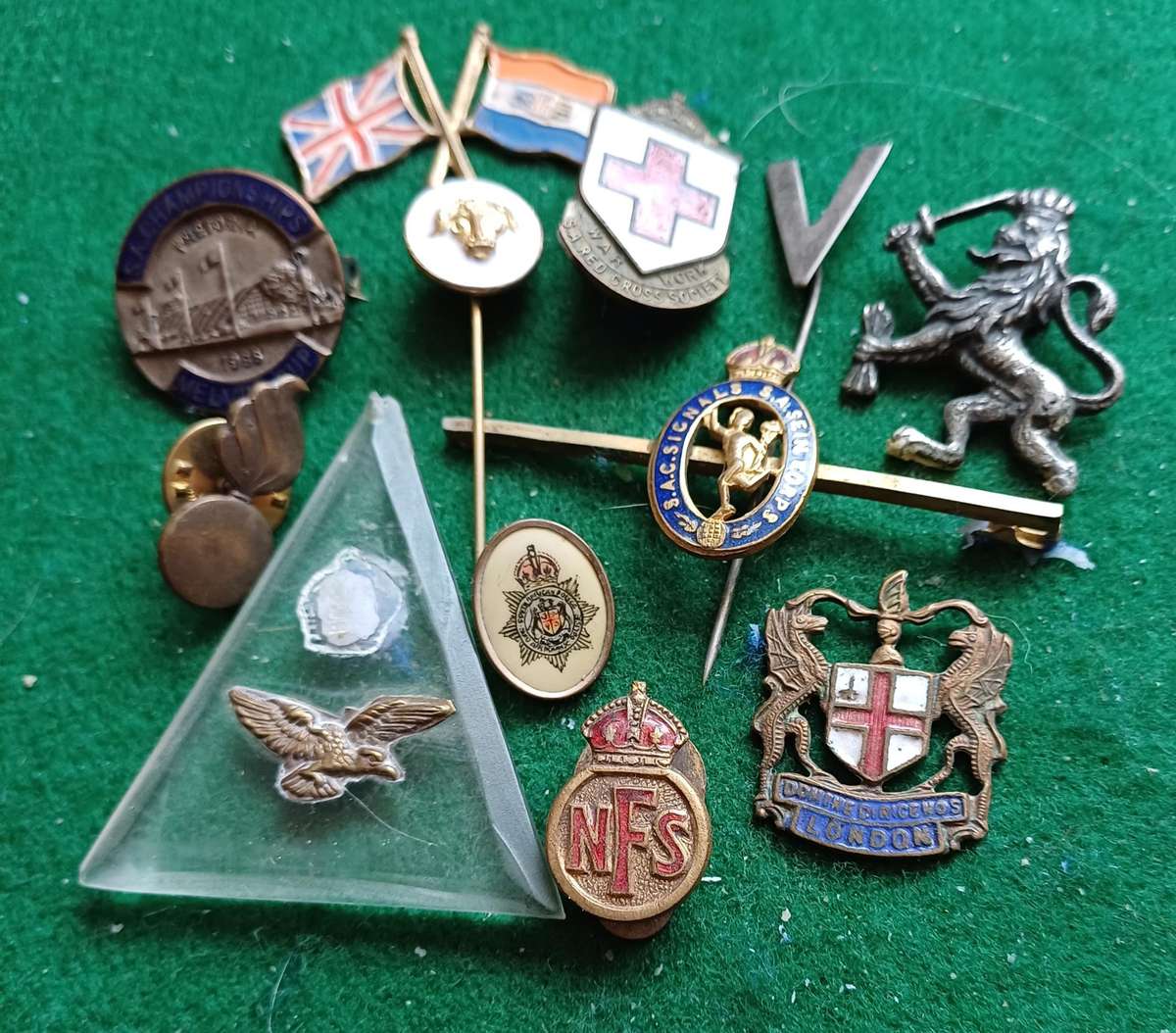 Selection of 12 military badges, sold as seen