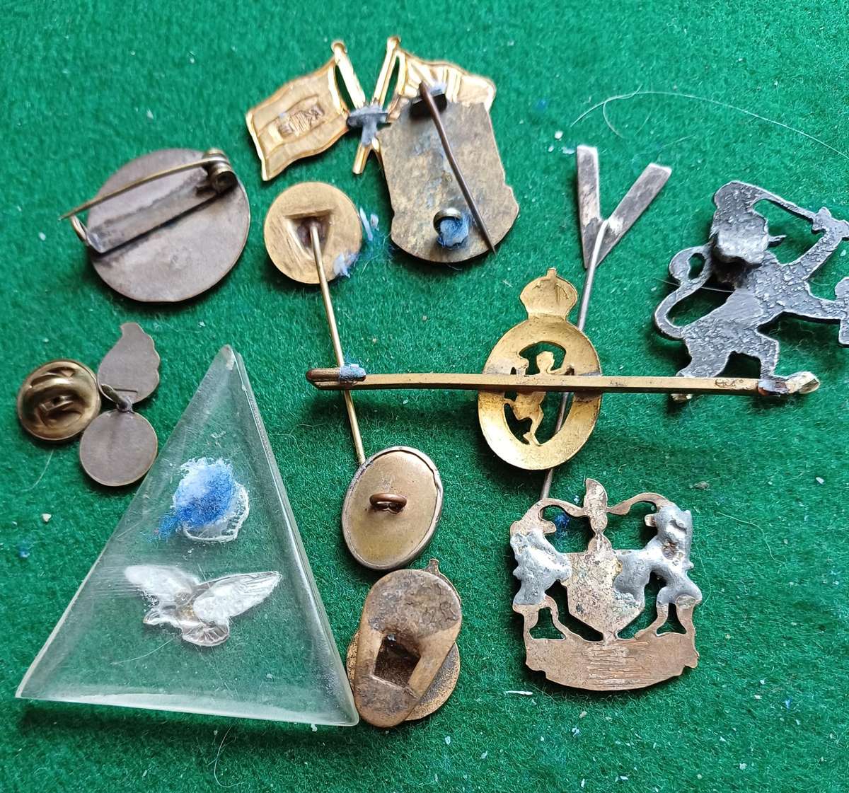 Selection of 12 military badges, sold as seen