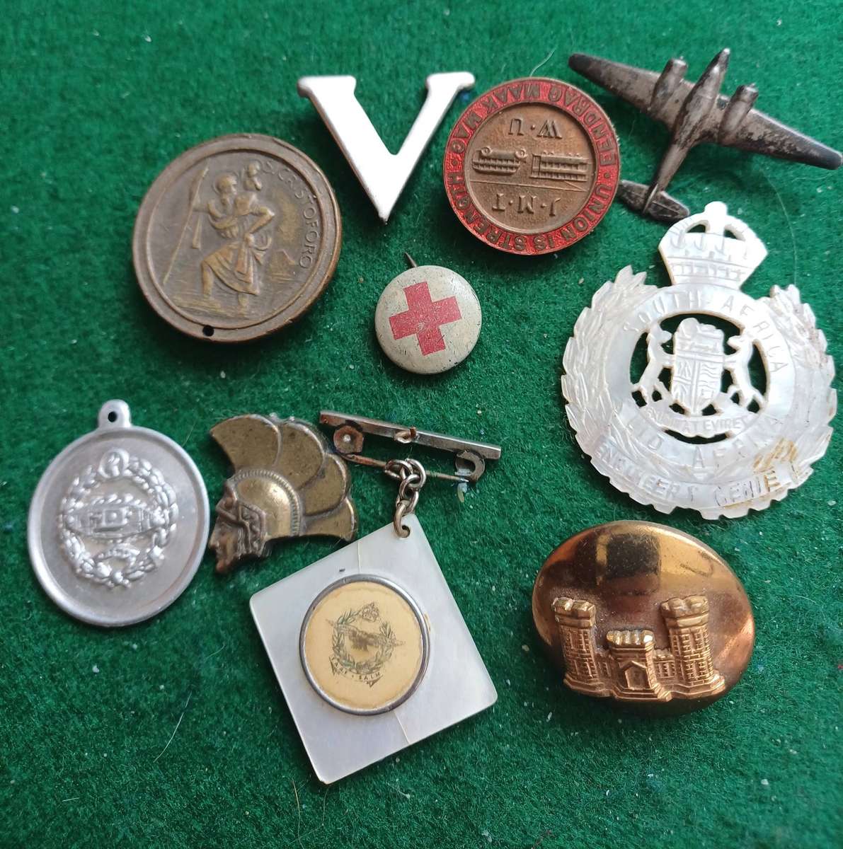 Selection of 10 military badges, sold as seen