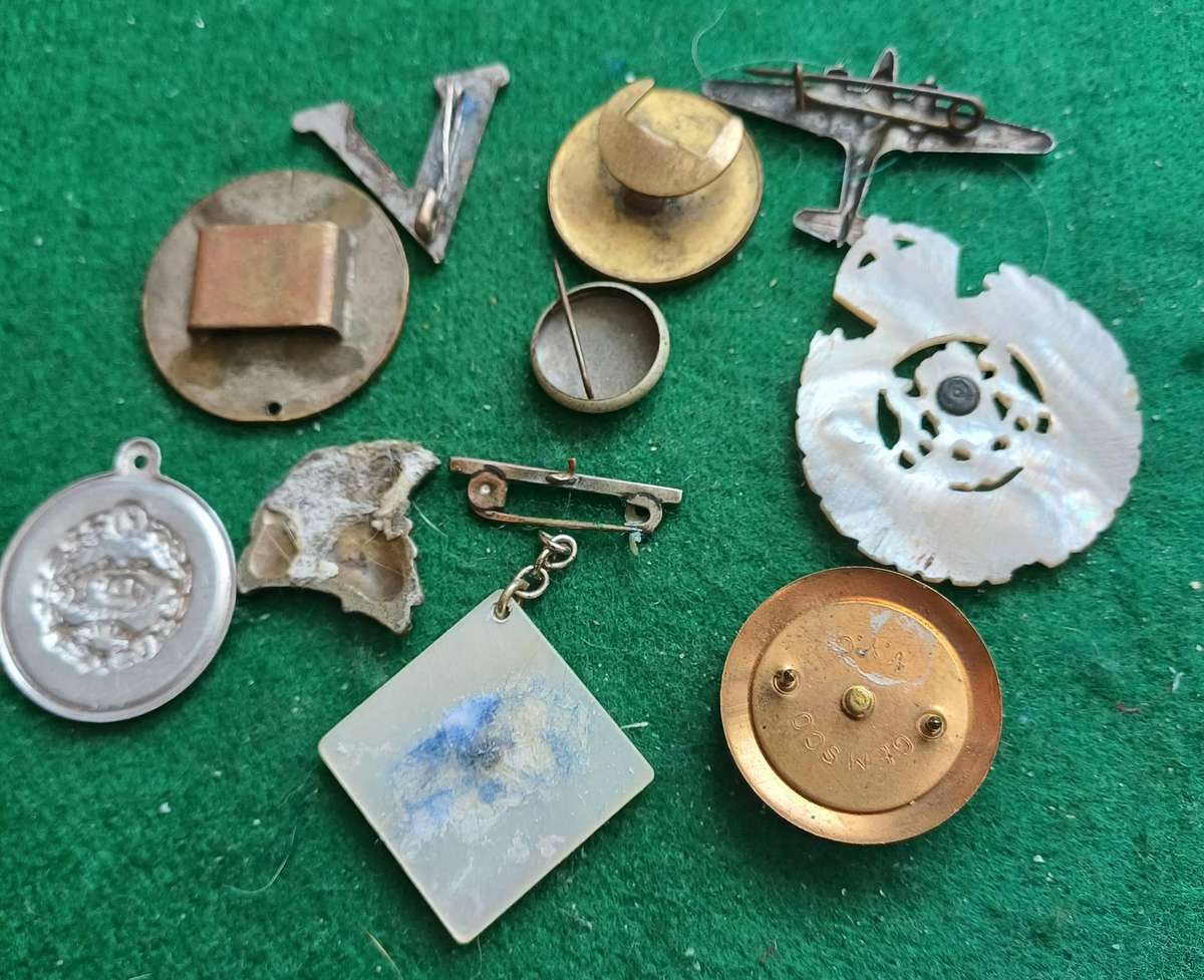 Selection of 10 military badges, sold as seen