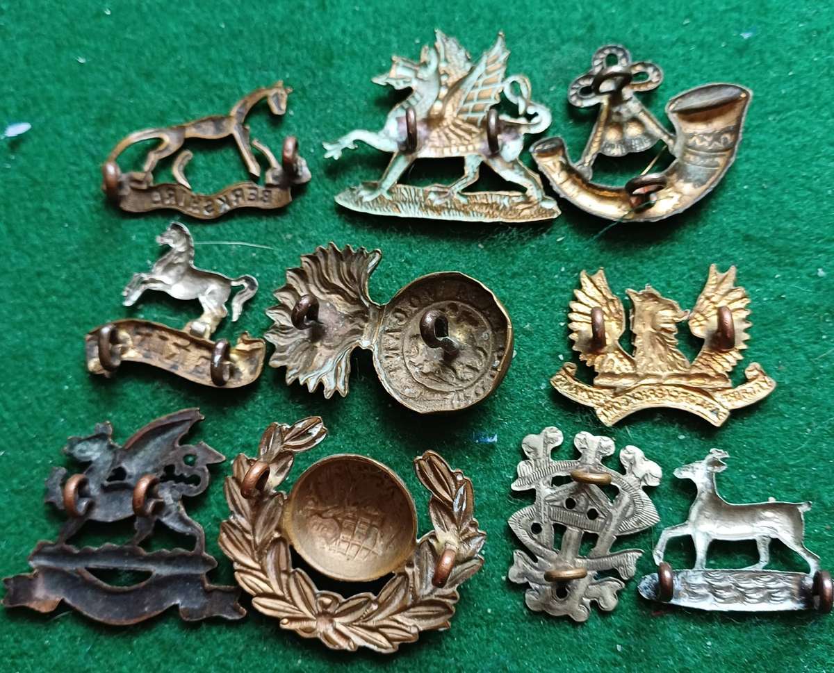 Selection of 10 military badges 3 inc Buffs Officers collar