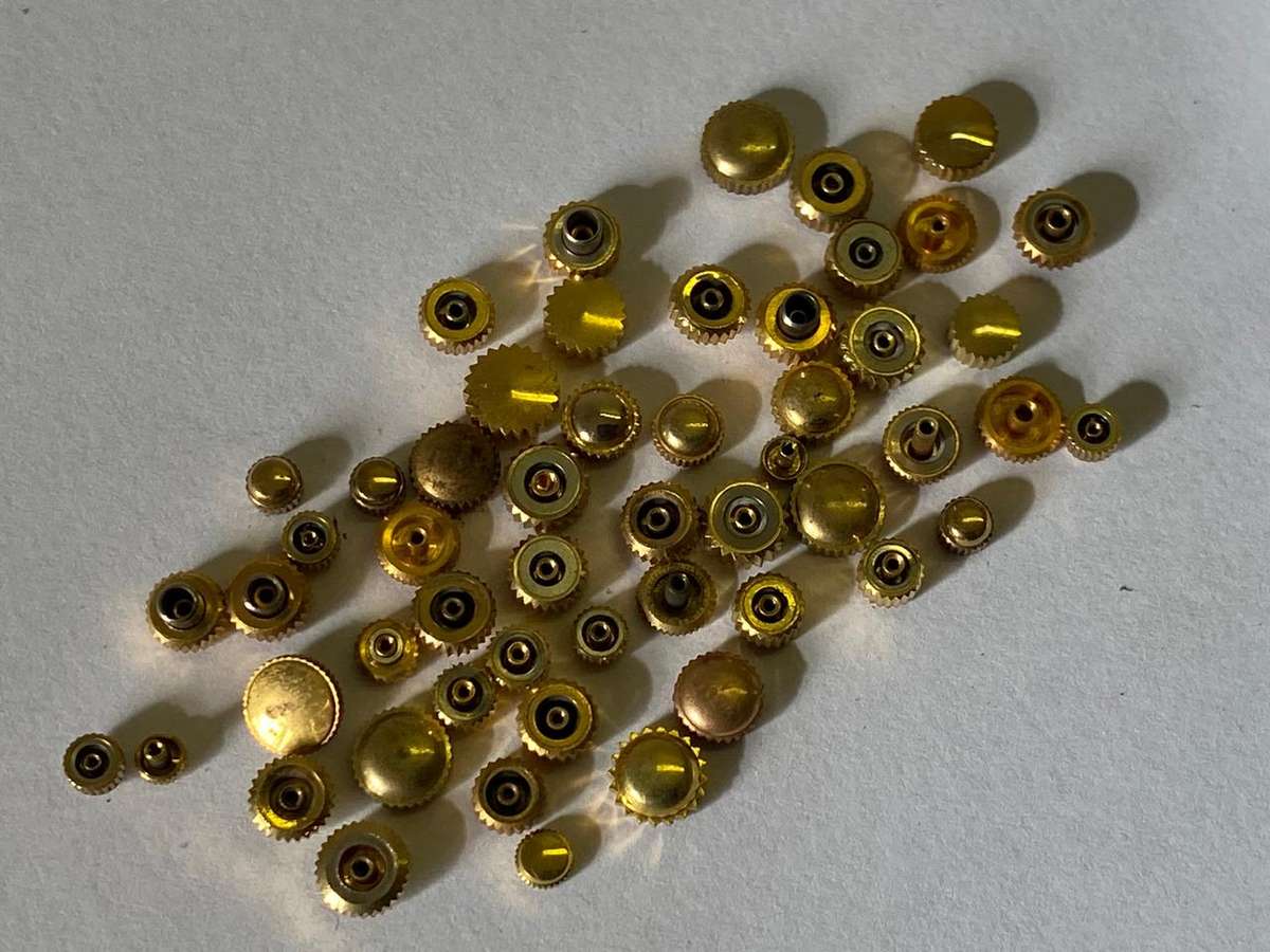 Assorted gold watch crowns - 50+ pieces