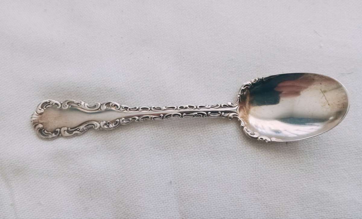 A sterling silver ornate sugar spoon