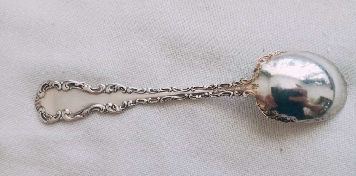 A sterling silver ornate sugar spoon
