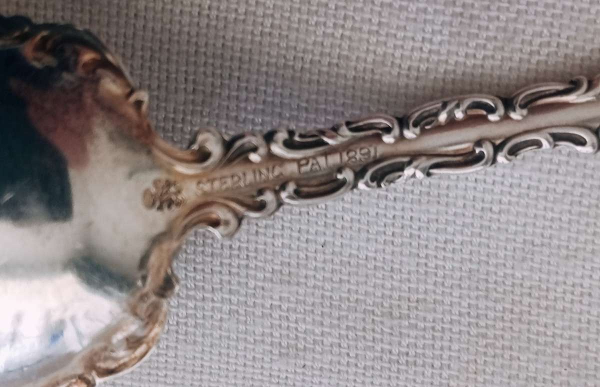 A sterling silver ornate sugar spoon