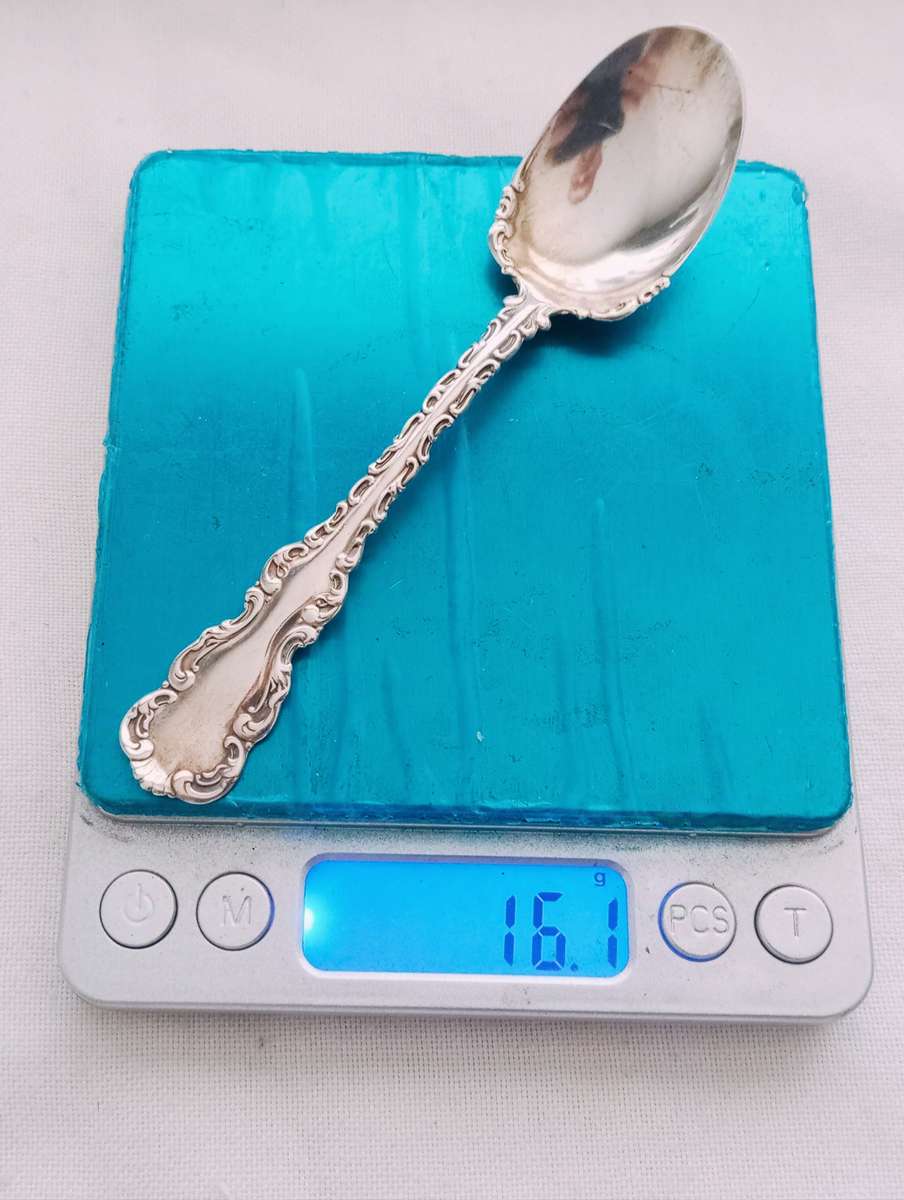 A sterling silver ornate sugar spoon